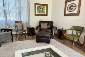 Living room with chairs and coffee table.